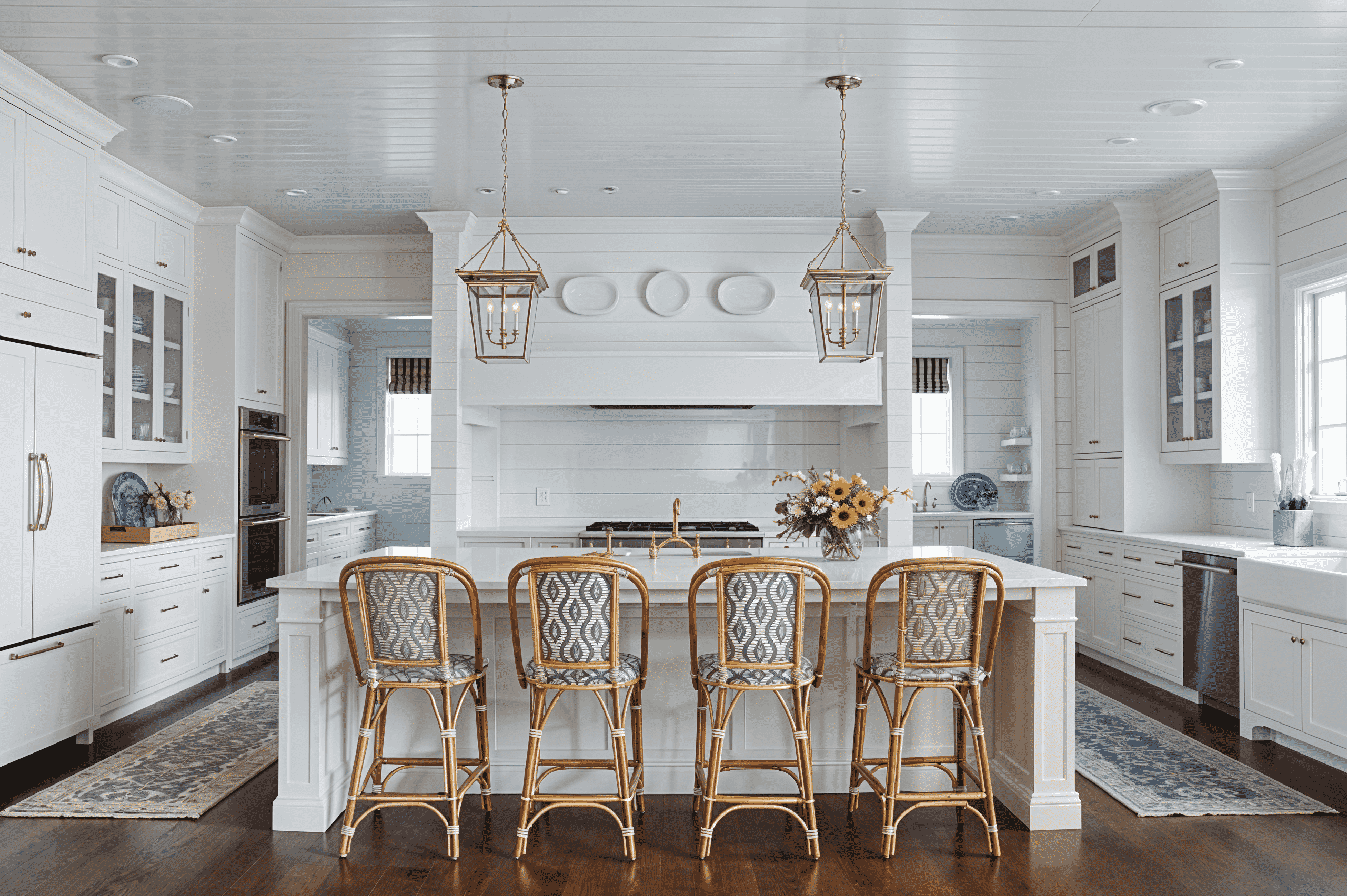 a kitchen with a center island with four stools